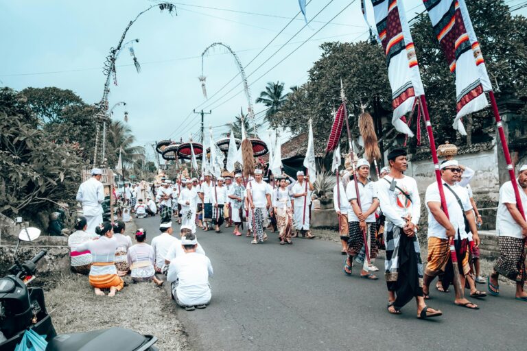 A procession of people in traditional Balinese attire during the Melasti purification ceremony