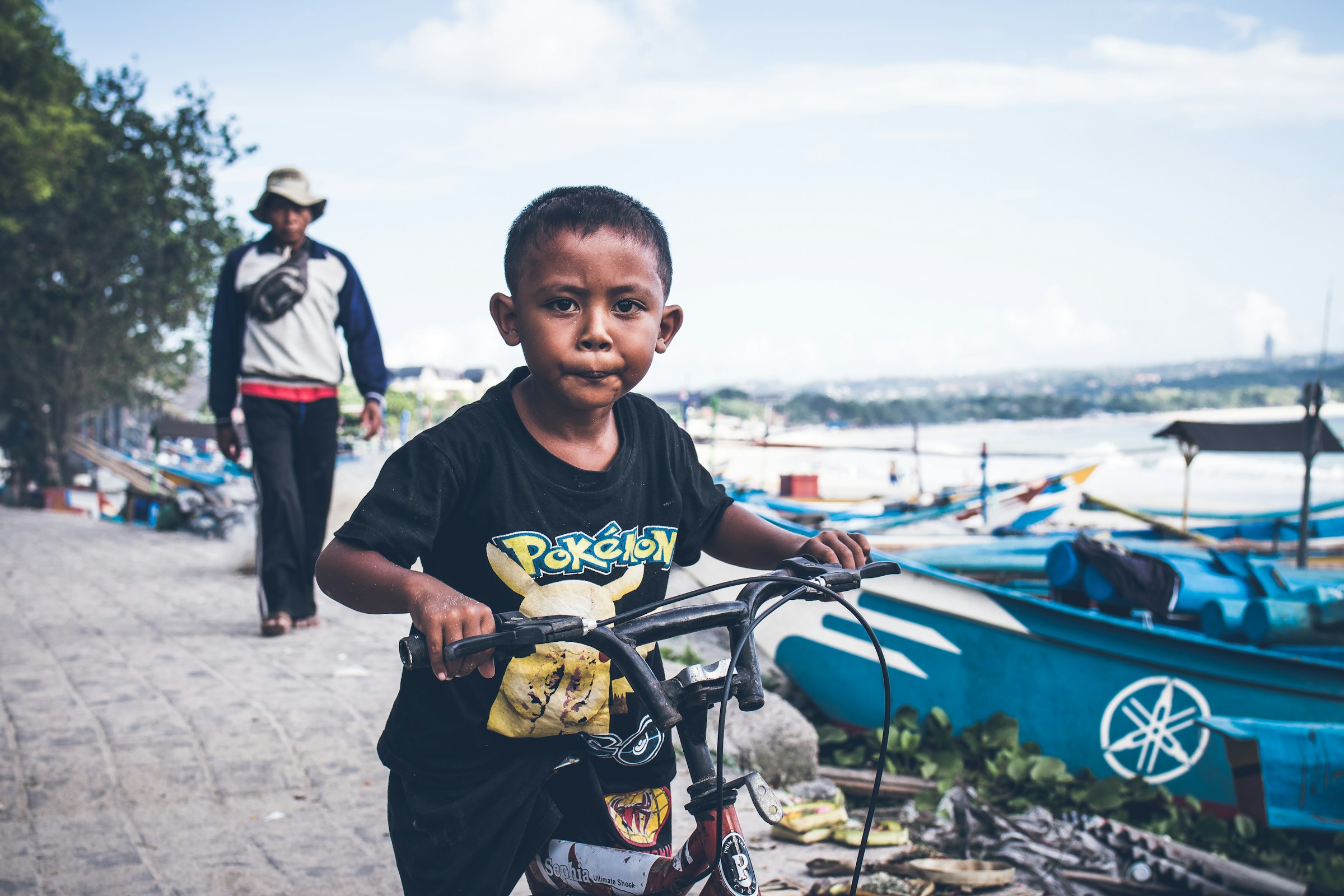 A young rider on a scooter on a street in Bali, Indonesia