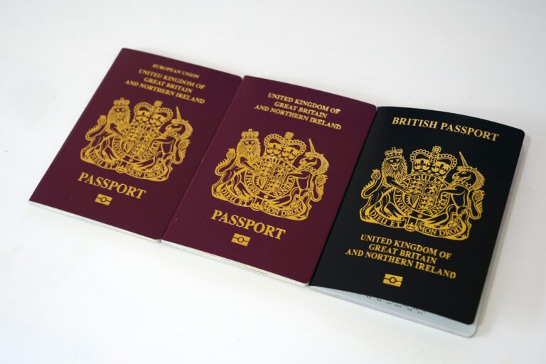 Three passports of different eras laid out showing design changes over time