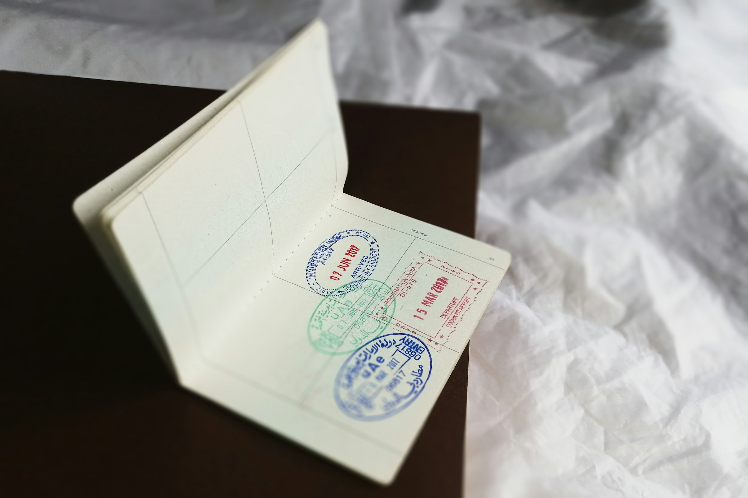 Close-up of an official travel document with multiple stamps affixed
