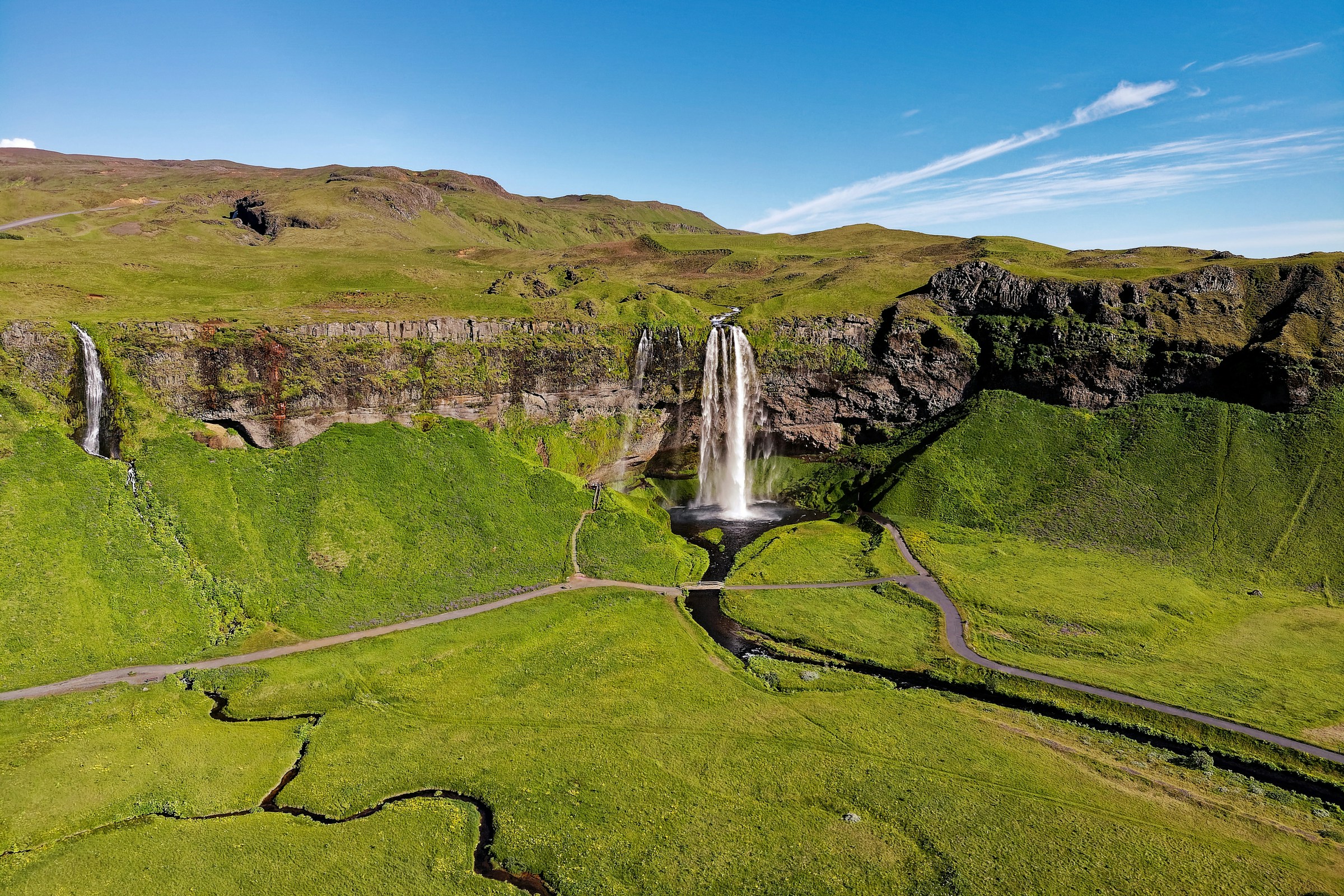 Aerial view of Seljalandsfoss waterfall cascading over green cliffs in Iceland