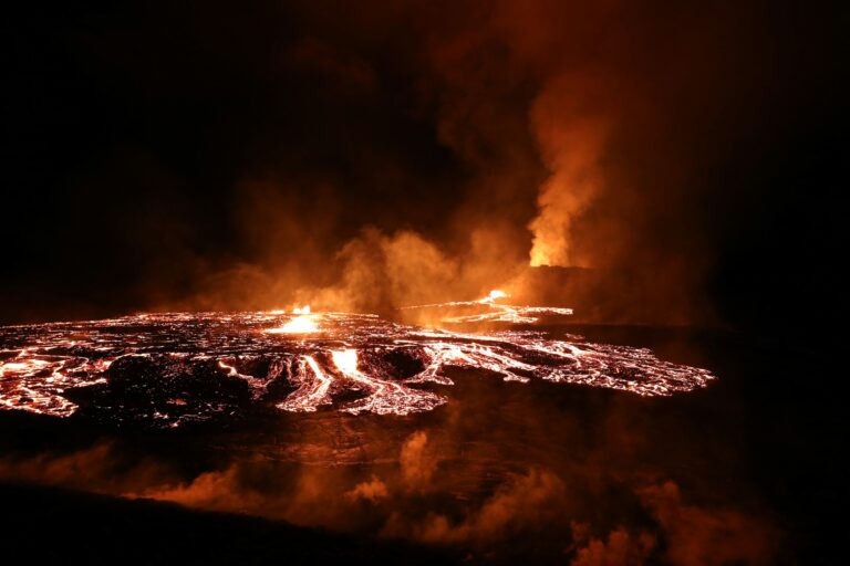 Glowing molten lava from a volcanic eruption at Fagradalsfjall, Iceland, at night