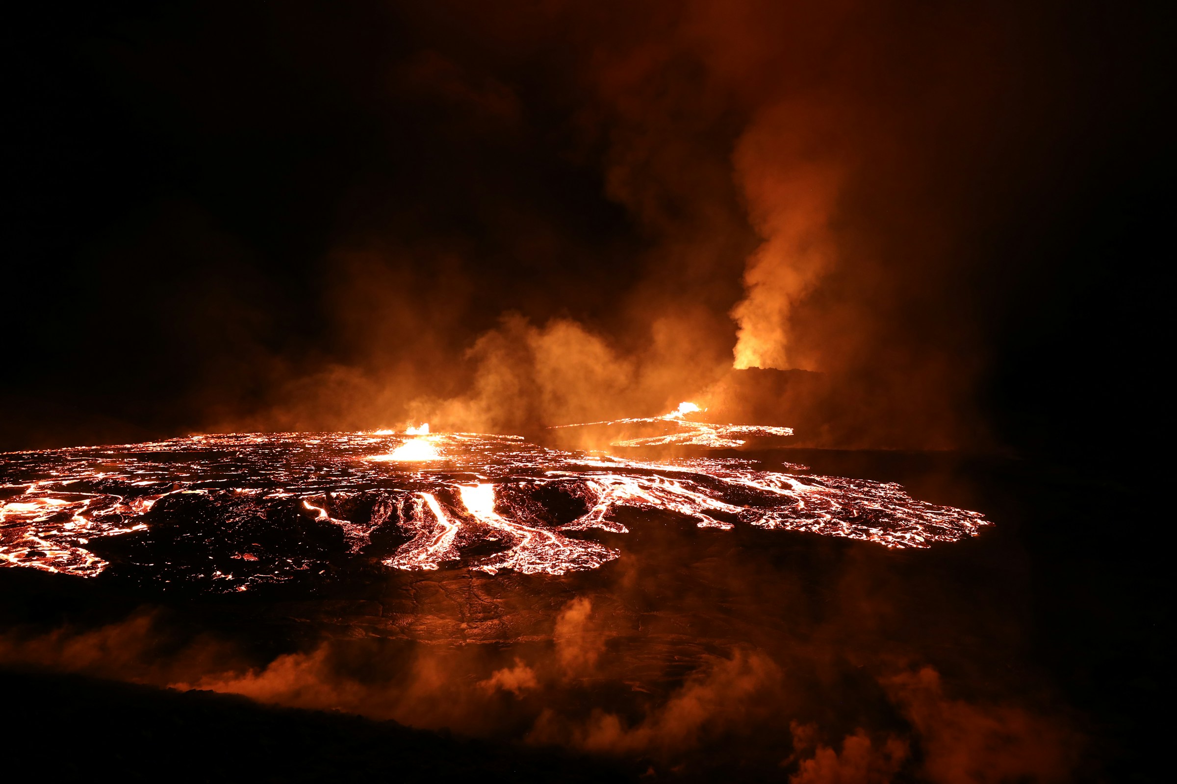 Glowing molten lava from a volcanic eruption at Fagradalsfjall, Iceland, at night