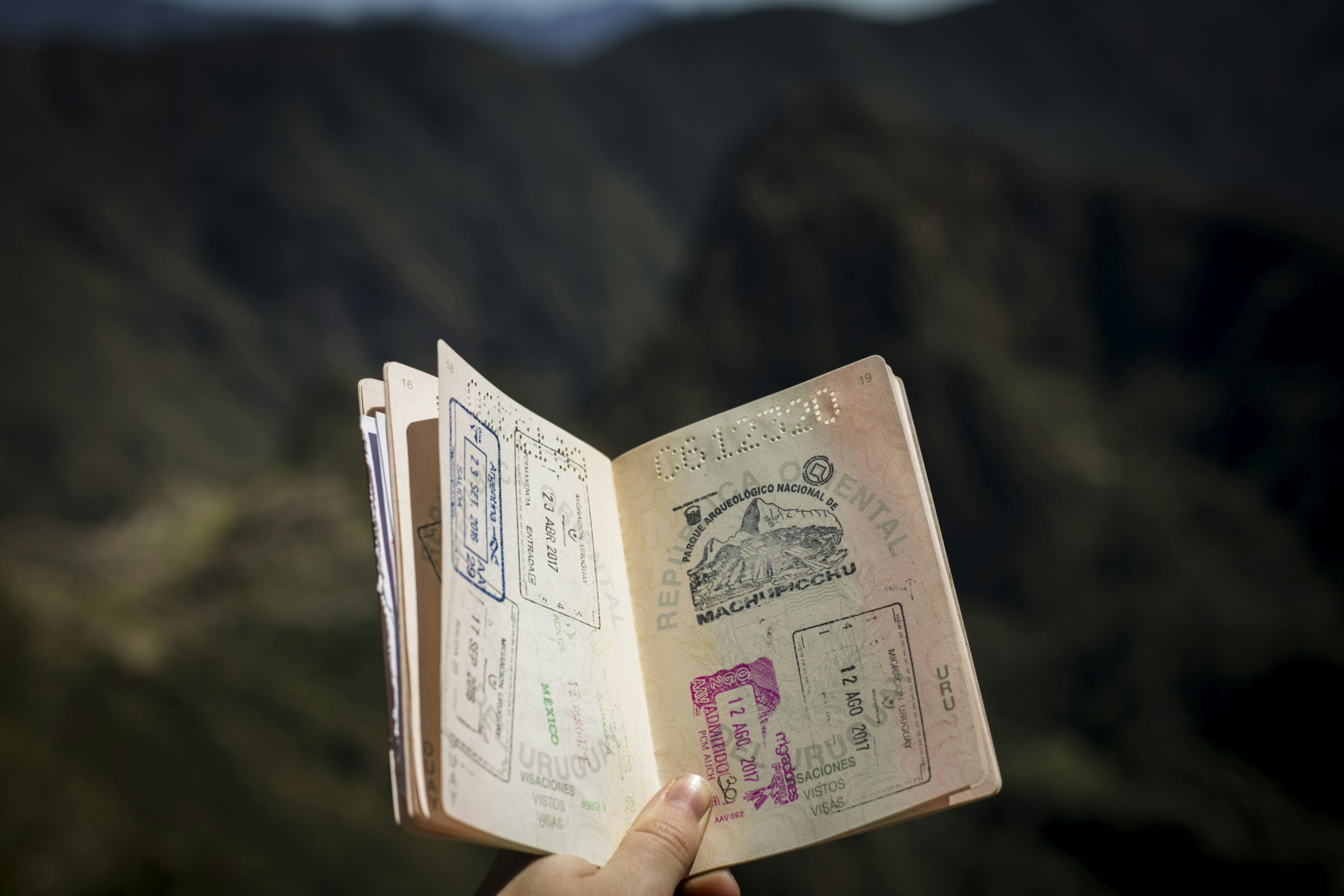 Close-up of a traveler holding an international passport before departure