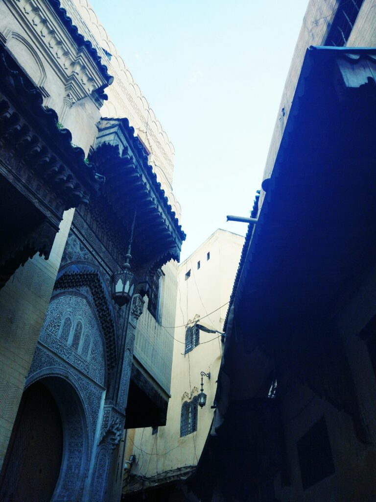 A narrow, historic alleyway in the old medina of Fes, Morocco