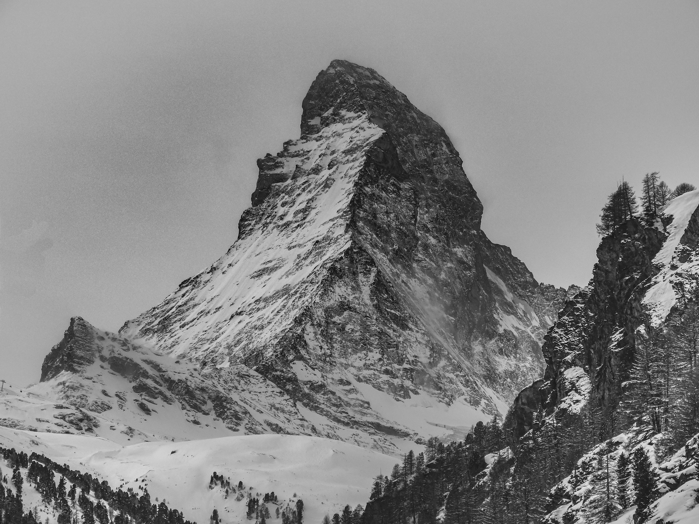 The snow-covered peak of the Matterhorn in winter conditions above Zermatt, Switzerland