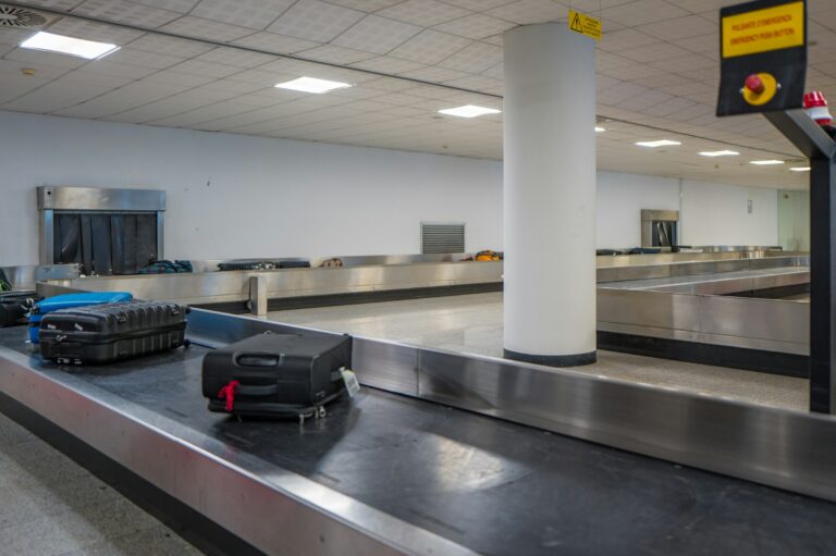 Suitcases and bags moving along an airport baggage claim conveyor belt