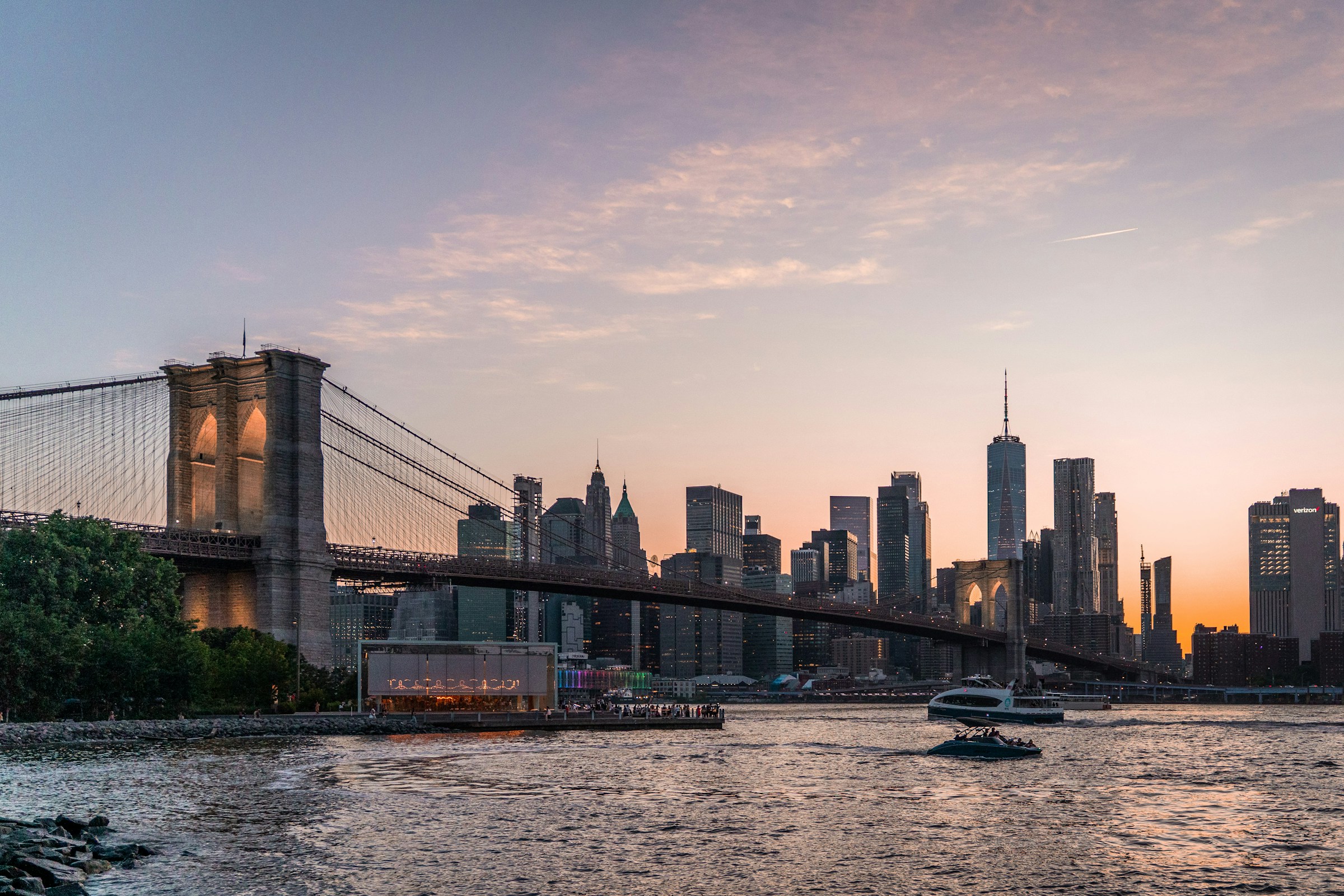 The Brooklyn Bridge with the Manhattan skyline glowing at sunset